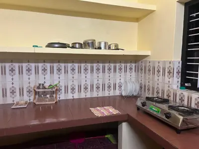 a kitchen with a stove and a counter top at Bluebell Homes B- 2bhk Upstairs in Kozhikode