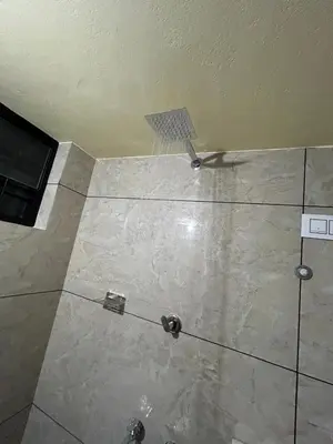 a bathroom with a tile floor with a screwdriver at Bluebell Homes B- 2bhk Upstairs in Kozhikode
