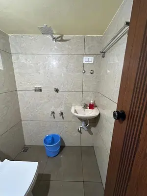a bathroom with a sink and a toilet and a shower at Bluebell Homes B- 2bhk Upstairs in Kozhikode
