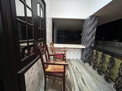 two chairs sitting on top of a balcony at Bluebell Homes B- 2bhk Upstairs in Kozhikode