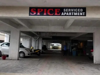 a parking garage with cars parked in it at SPICE HOMESTAY Apartment in Singānallūr