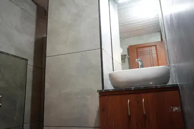 a bathroom with a sink and a mirror at Pearl Residency Kalady in Kāladi