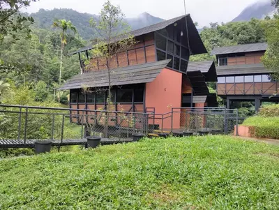 a house on top of a grassy hill at Moonrise Valley Freshwave Resorts Pvt Ltd in Koroth