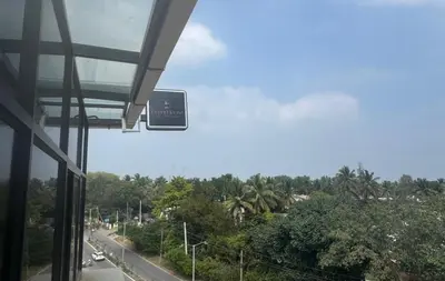 a view of a street from a building with a sign at Event House, Mysore in Mysore