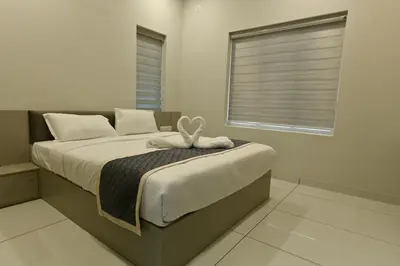 a bedroom with a bed with a blanket and a window at Star Guest House