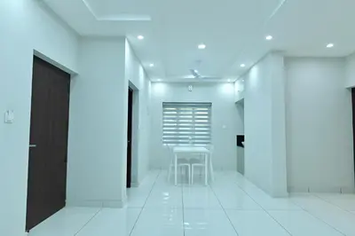 a white hallway with a table and a chair at Star Guest House
