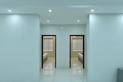 a hallway with two mirrors and a blue wall at Star Guest House