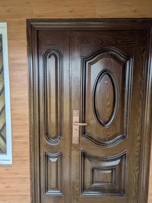 a wooden door in a room with at Ivy hostel ooty in Ooty