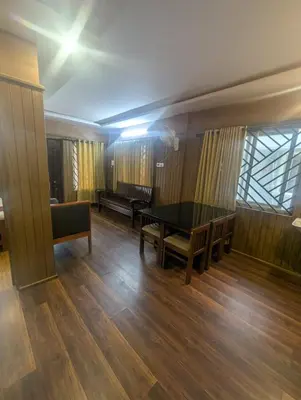 a room with a ping pong table and benches at Ivy hostel ooty in Ooty