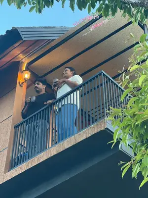 two men standing on a balcony of a building at Mount Lux Villa in Devāla