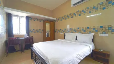 a bedroom with a bed and a table in it at Citrus stays Nr bosch,infosys kalapatti in Coimbatore