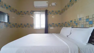 a white bed in a room with a window at Citrus stays Nr bosch,infosys kalapatti in Coimbatore