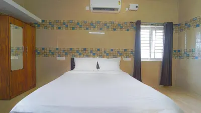a large white bed in a room with a window at Citrus stays Nr bosch,infosys kalapatti in Coimbatore