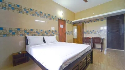 a bedroom with a bed and a room with a table at Citrus stays Nr bosch,infosys kalapatti in Coimbatore