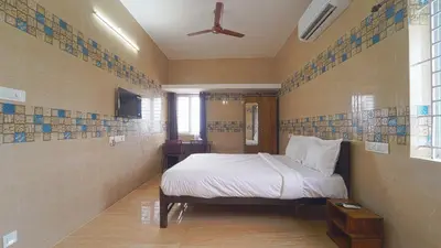 a bedroom with a bed and a ceiling fan at Citrus stays Nr bosch,infosys kalapatti in Coimbatore