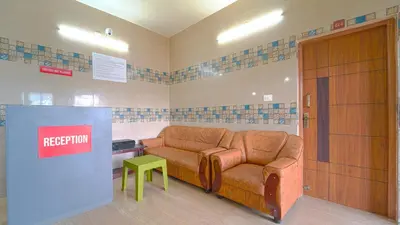 a waiting room with a couch and a table at Citrus stays Nr bosch,infosys kalapatti in Coimbatore