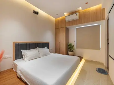 a bedroom with a white bed and a window at Palette Serenity by CheckIn | 2 BHK Apartment | Coimbatore in Coimbatore