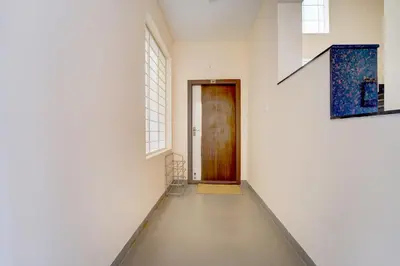 an empty hallway with a door and a window at Palette Serenity by CheckIn | 2 BHK Apartment | Coimbatore in Coimbatore