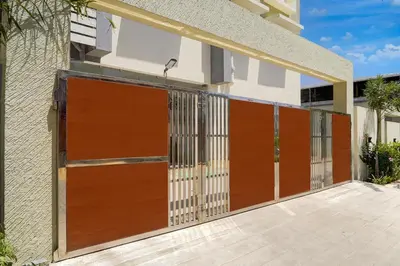 a pair of wooden garage doors on a building at Palette Serenity by CheckIn | 2 BHK Apartment | Coimbatore in Coimbatore