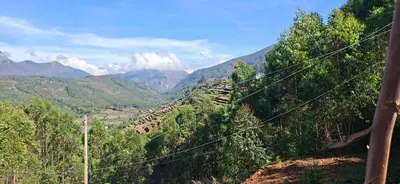 a view of a valley with mountains in the background at Dadysmud house in Kottakamboor
