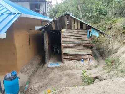 a building with a door in the side of it at BREEZE GARDEN MUD HOUSE Home Stay in Kanthalloor