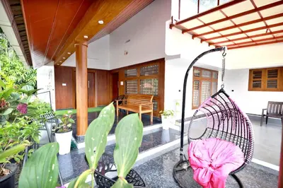 a swing in the middle of a porch with plants at MT'S Villas in Batheri