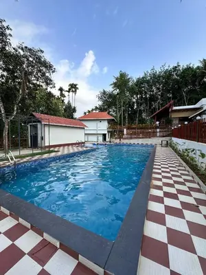 a large swimming pool with a checkeredkered floor at MT'S Villas in Batheri