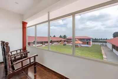 a room with a bench and a large window at Kamath Village Resortz