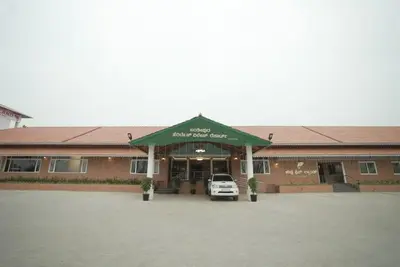 a car parked in a parking lot in front of a building at Kamath Village Resortz