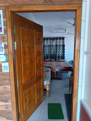 a door leading into a room with a bed at Private Room with Kitchen for Decent Couples & Families in Mysore