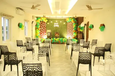a room with a bunch of chairs and balloons at Parva Residency in Palladam