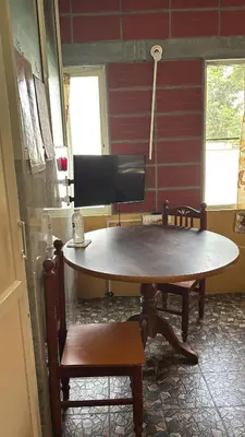 a table and two chairs in a room at Garden Room for a Couple in Mysore