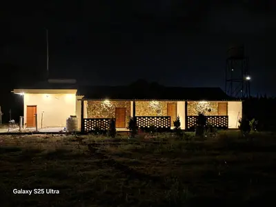 a house lit up at night with christmas lights at Rangers Nest Bandipur in Gundlupet