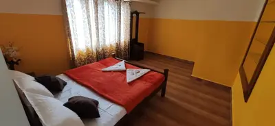 a bedroom with a bed with two napkins on it at Nivriti Cottage Valley View Stay in Ooty