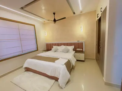 a bedroom with a large bed and a large window at Bayfront Bliss - Flat 3BHK in Calicut Beach-Wakeup to stunning views in Kozhikode