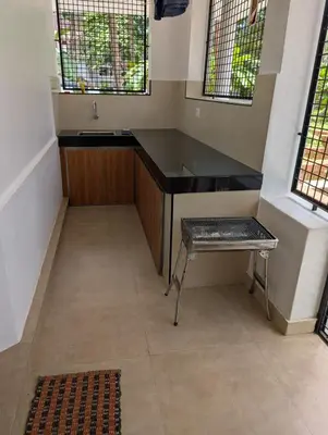 a bathroom with a sink and a bench in a room at Traditional Kerala house, Thalassery, Kannur in Tellicherry