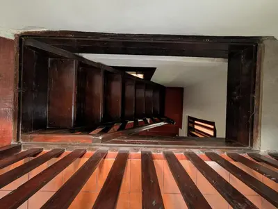 an empty room with wooden stairs in a building at Traditional Kerala house, Thalassery, Kannur in Tellicherry