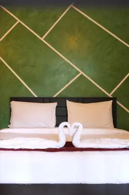a bed with a heart shaped pillow on it at Skyfall adventure rooms in Meppādi