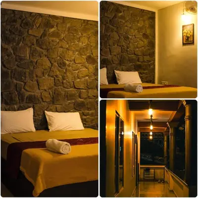 two pictures of a room with two beds and a stone wall at Skyfall adventure rooms in Meppādi
