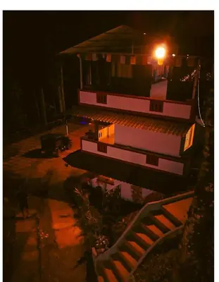 a building with a light on top of it at night at Skyfall adventure rooms in Meppādi