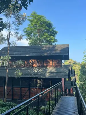 a house with a wooden walkway leading up to it at Fresh Wave Resort And Pool Villa Soochipara in Meppādi