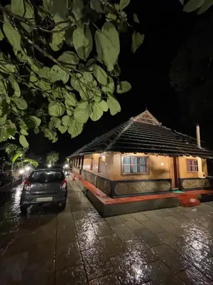 a car parked in front of a house at night at Aravanazhi tharavadu in Thirunelli