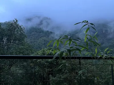 a view of a mountain with clouds in the background at Luxury Villa in Wayanad Hills with Private Garden in Wayanad