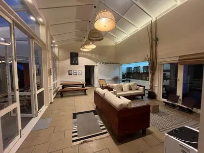 a living room with a couch and a table at Luxury Villa in Wayanad Hills with Private Garden in Wayanad