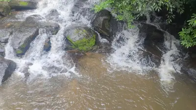a waterfall on the side of a river at Haven heights in Kanthalloor