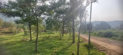 a dirt road with trees on the side of a field at Haven heights in Kanthalloor