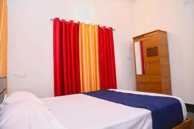 a bedroom with colorful curtains and a bed at Whispering Streams in Tariyod