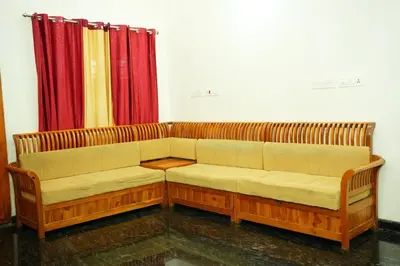 a couch sitting in a room with red curtains at Whispering Streams in Tariyod