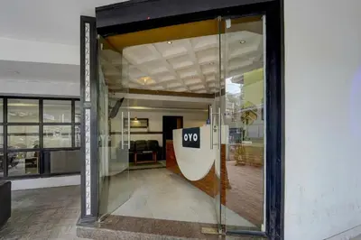 an open door of a building with a sign on it at Hotel O OZONE Residency in Kozhikode
