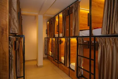 a row of bunk beds in a room at Stay Point Premium Capsule and Rooms in Calicut Beach in Kozhikode